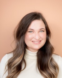 a woman with long hair and a turtle neck top